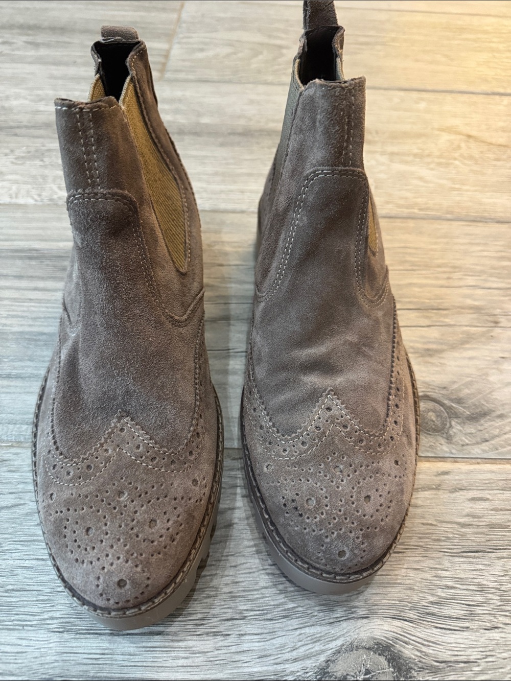 Women's Taupe Suede Wingtip ankle booties.